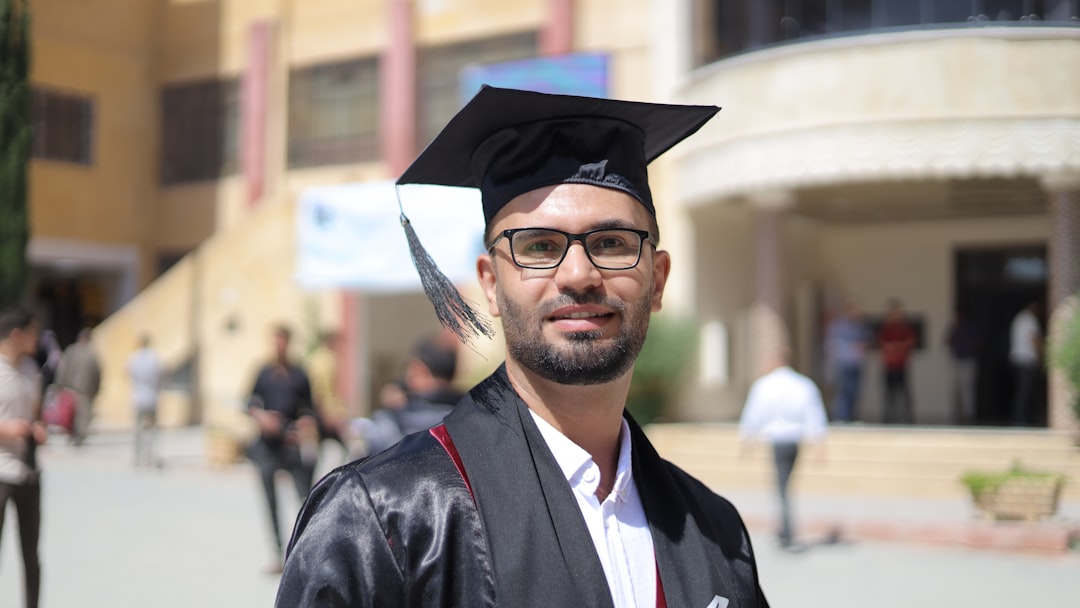 A graduate poses with graduation attire.