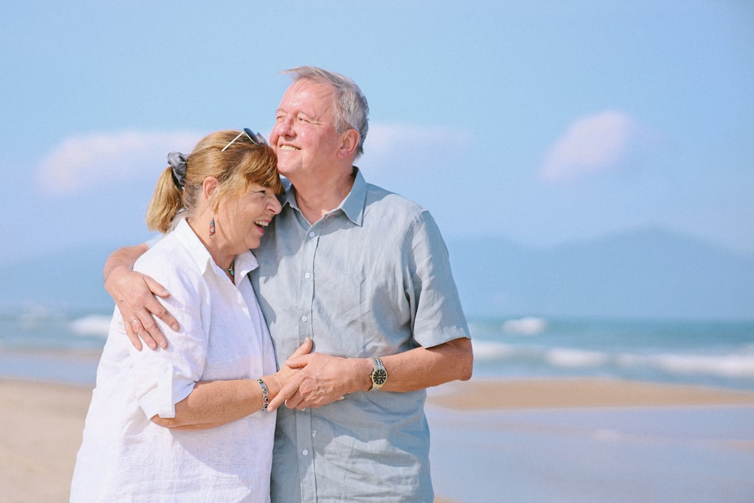 Elderly couple embracing on a sunny beach